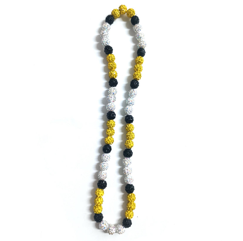 Necklace with yellow, black, and white beads on a white background