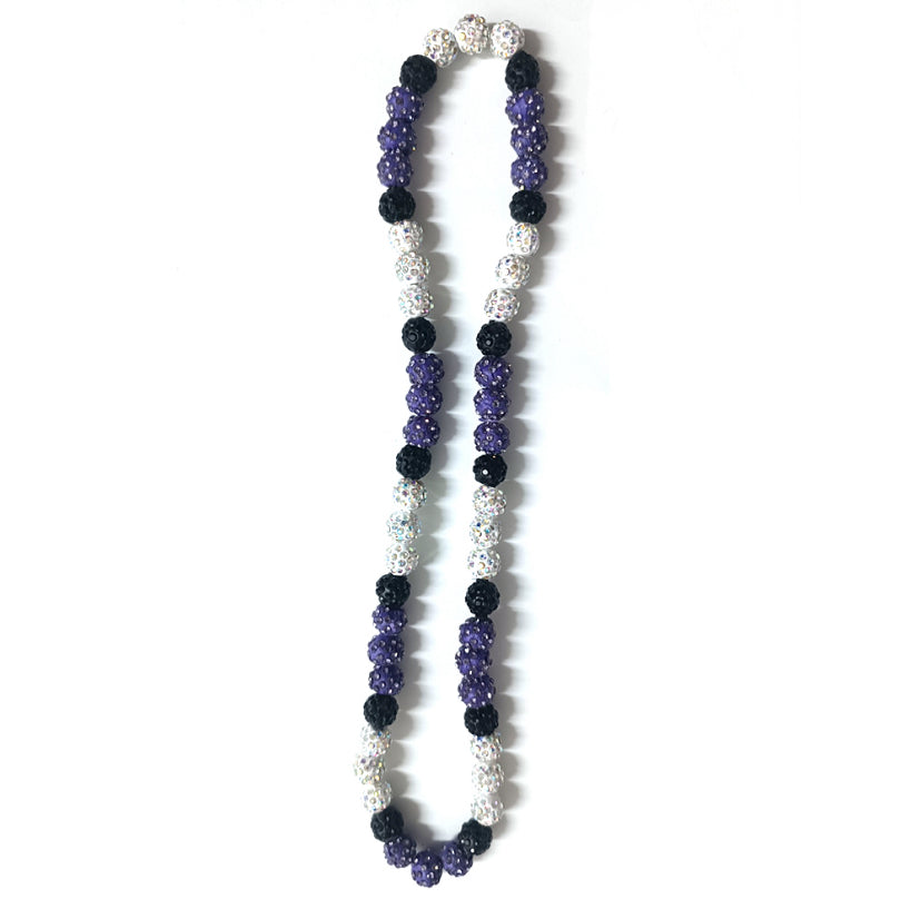 Necklace with purple, black, and white beads on a white background