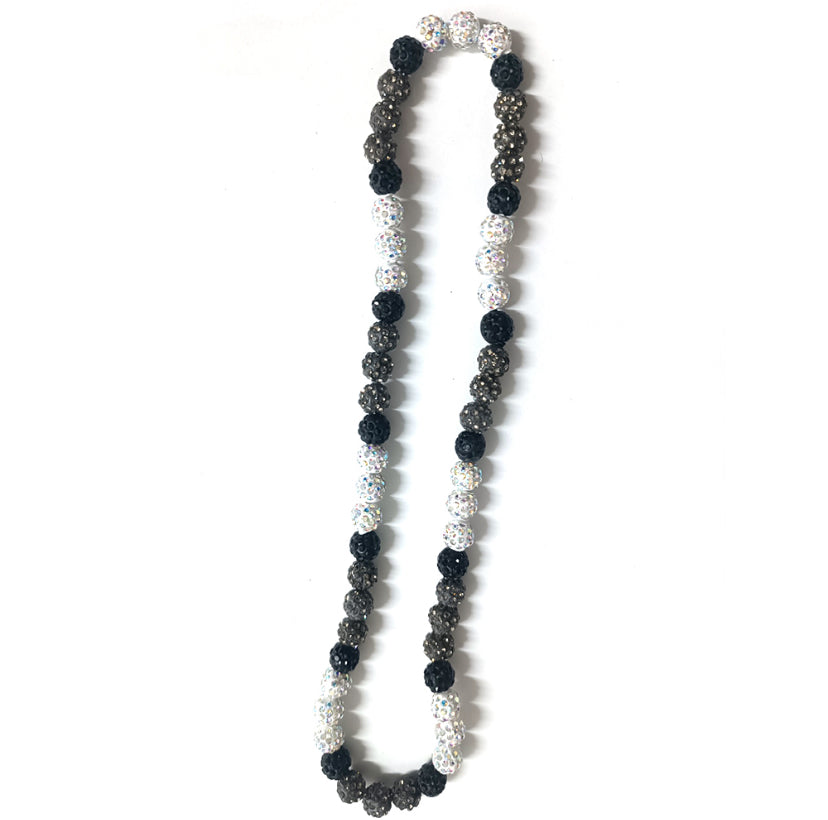 Necklace with black, white, and silver beads on a white background