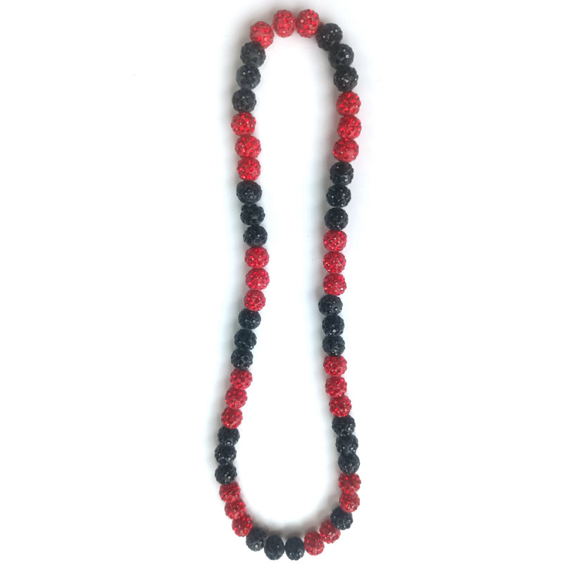 Necklace with red and black beads on a white background