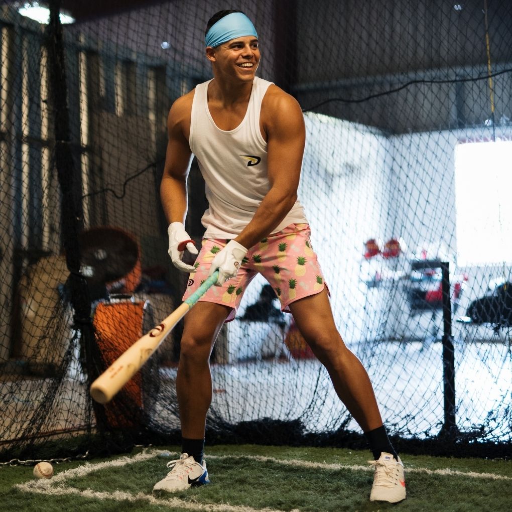 Baseball player hitting with cool shorts